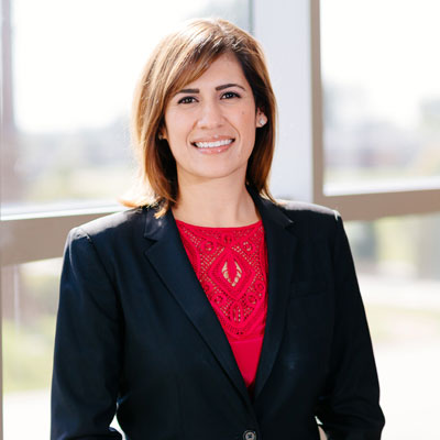 Attorney Jennifer Ruiz standing in front of window